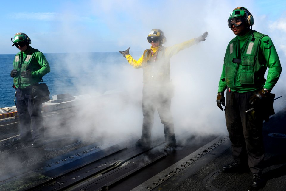 A Sailor directs aircraft at sea. (8407483477)