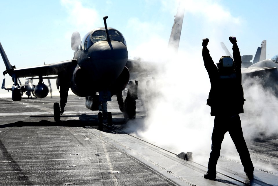 A Sailor directs an EA-6B at sea. (8408578010)