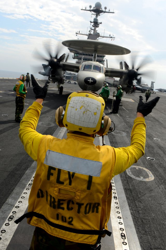 A Sailor directs an E-2C at sea. (8270223546)