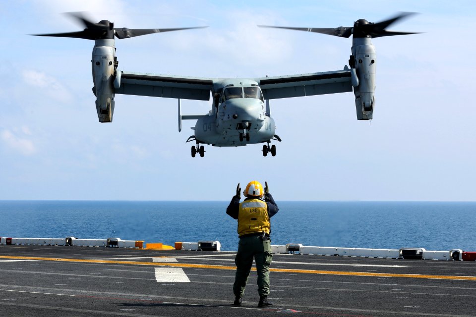 A Sailor directs an MV-22 at sea. (8497232281)