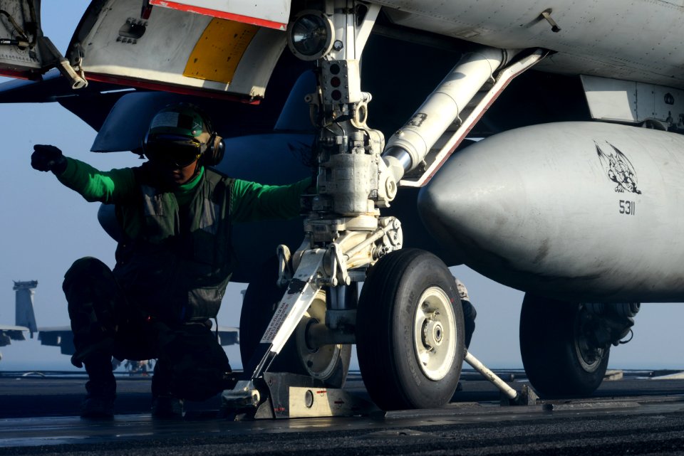 A Sailor directs an F-A-18C at sea. (8426059959)