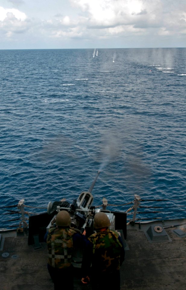 A Sailor fires a 50 mm gun aboard USS Winston S. Churchill. (8595820218)