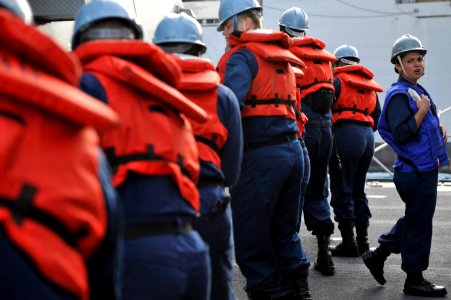 A Sailor directs line handlers at sea. (8244608286)