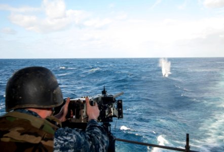 A Sailor fires a machine gun at sea. (8516138540)
