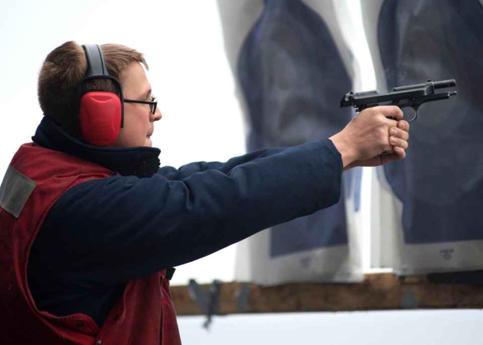 A Sailor fires an M9 pistol aboard USS Boxer. (8597781488)