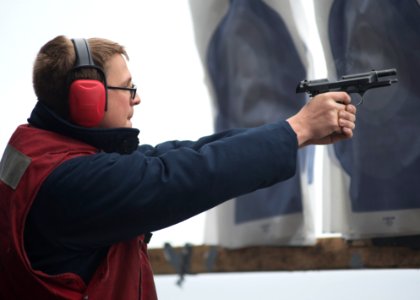 A Sailor fires an M9 pistol aboard USS Boxer. (8597781488)