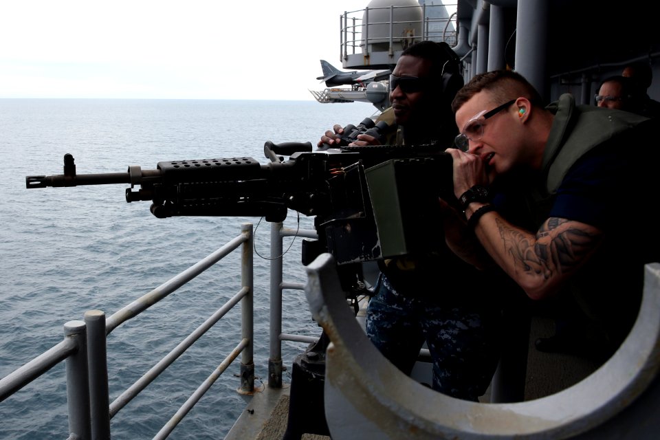 A Sailor fires an M240B machine gun at sea. (8456178224)