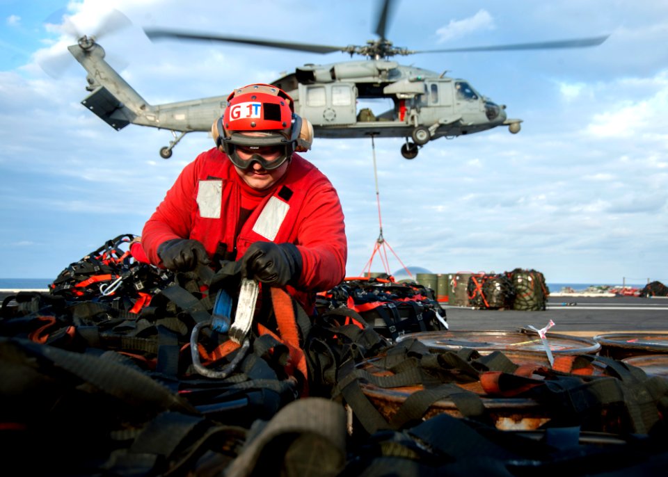 A Sailor detaches cargo nets aboard USS Harry S. Truman. (8407486359)