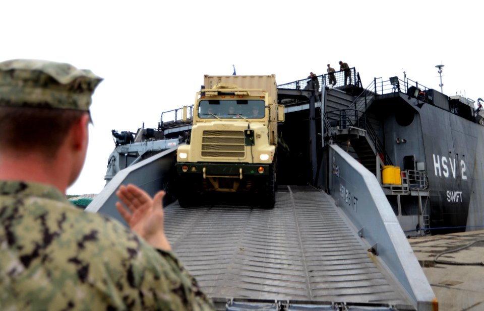 A Sailor directs a truck off HSV 2. (8498336922)