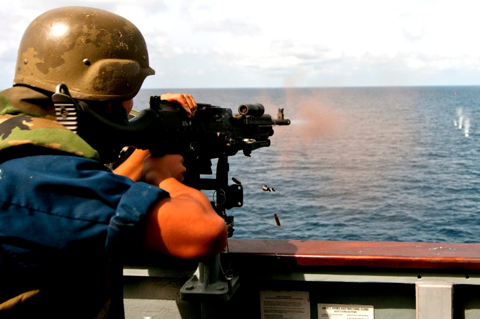 A Sailor fires an M240B machine gun at sea. (8594719851)