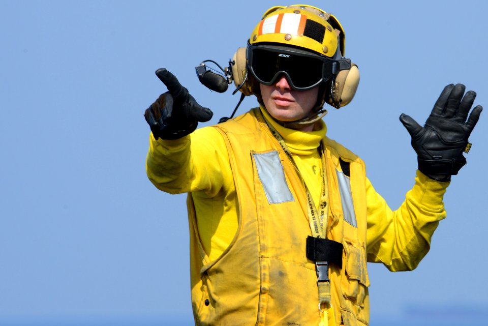 A Sailor directs aircraft at sea. (8414177278)