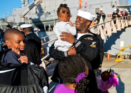A Sailor holds his daughter upon returning to Japan. (8199144171)