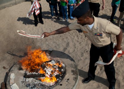 A Sailor helps retire a flag. (8574828270)