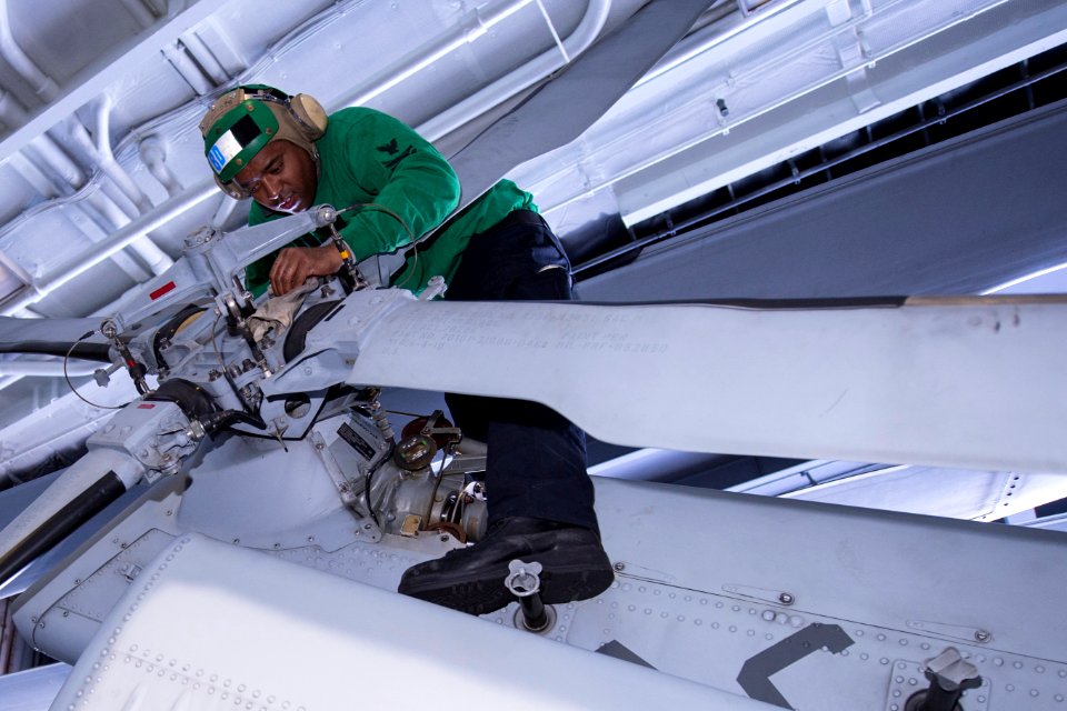 A Sailor inspects the tail rotor of a Sea Hawk. (8413362667)