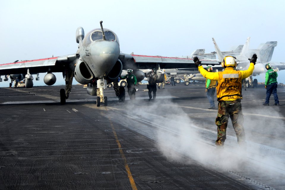 A Sailor directs an EA-6B at sea. (8428934761)
