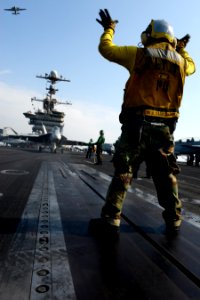 A Sailor directs an F-A-18E at sea. (8413079577)