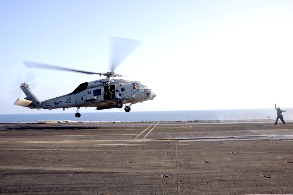 A Sailor directs an SH-60F aboard USS Dwight D. Eisenhower. (8592539202)