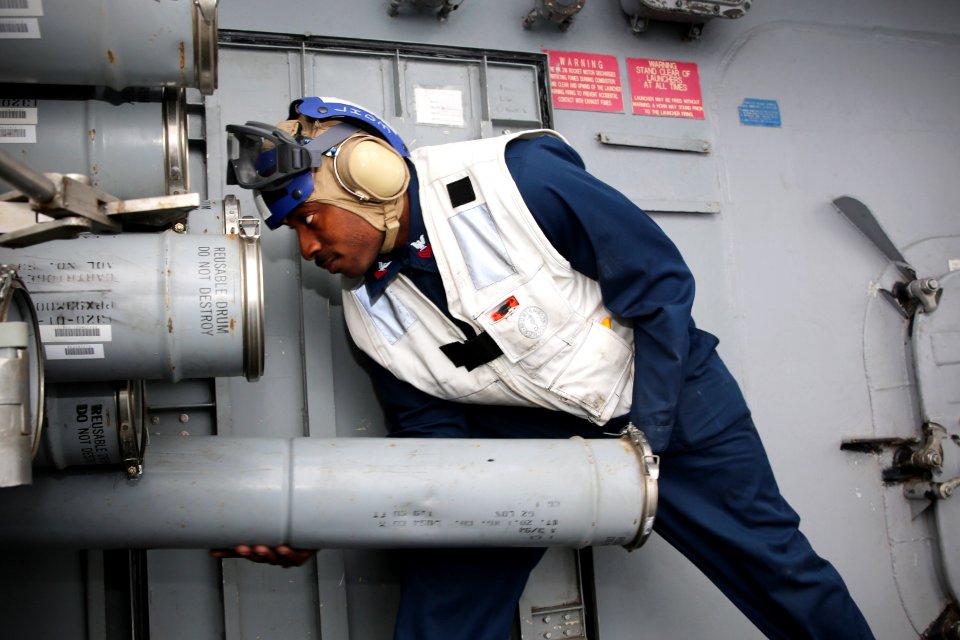 A Sailor loads a chaff round at sea. (8426061991)