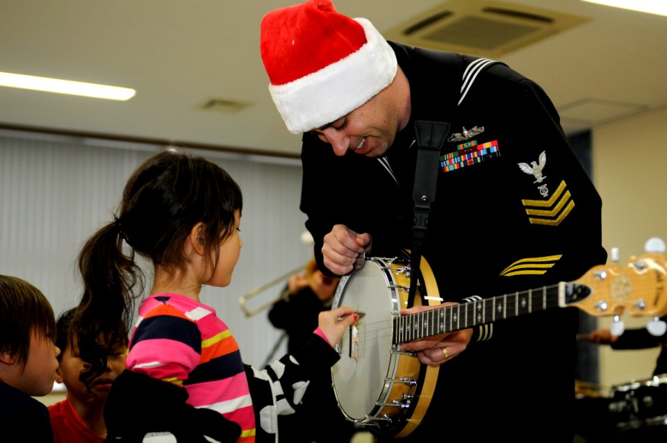 A Sailor plays banjo with a child. (8243543489)