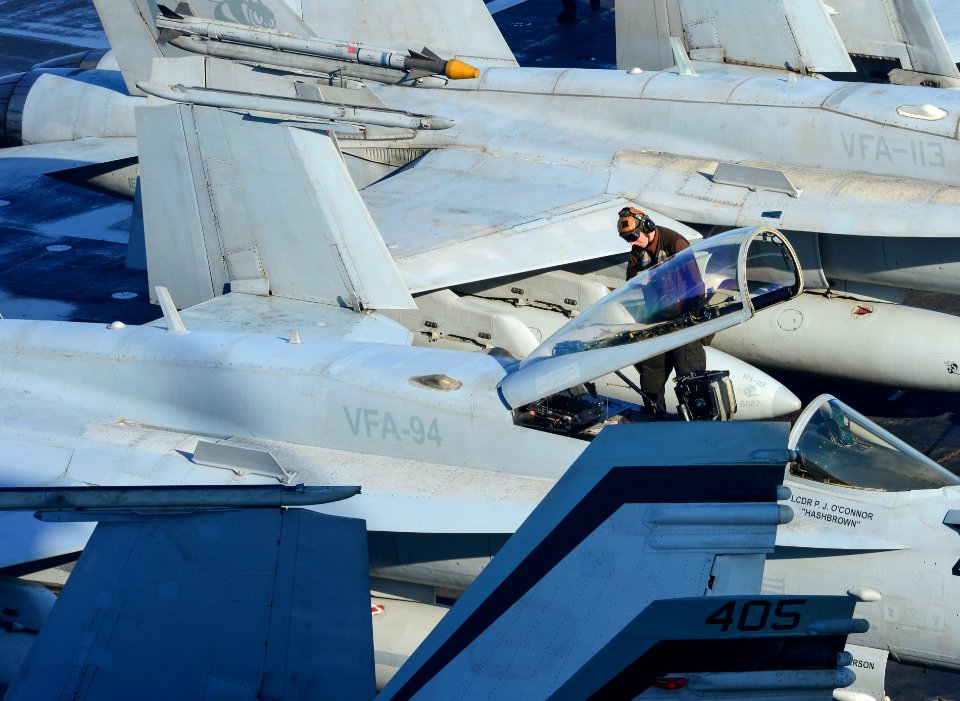 A Sailor maintains aircraft aboard USS Carl Vinson. (16715084802)