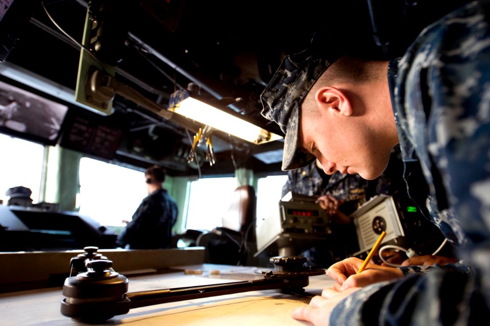 A Sailor plots the ship's course. (8414179658)