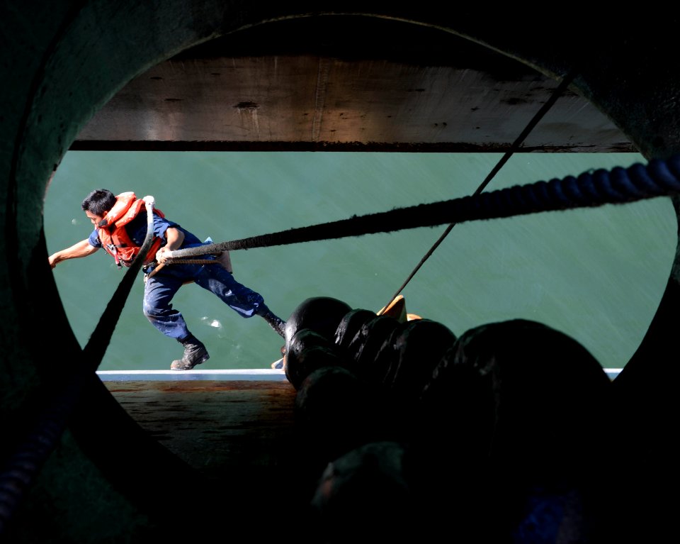 A Sailor paints the side of USS Mesa Verde. (15490866790)