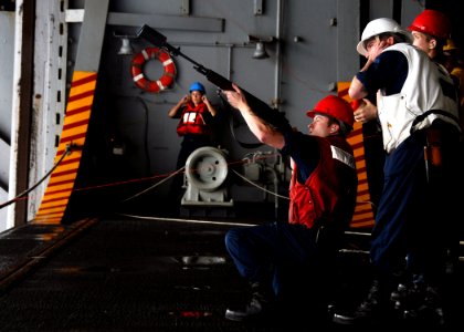 A Sailor prepares to shoot a line to another ship. (8200233436)
