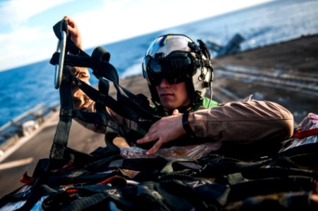 A Sailor removes a cargo net aboard USS Mobile Bay. (8467237643)