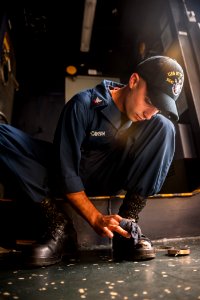 A Sailor shines his shoes before duty. (8559250987)