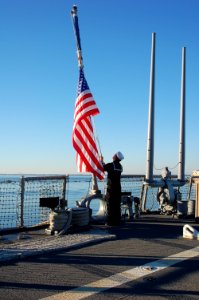 A Sailor lowers the flag to half-mast. (8283346037)