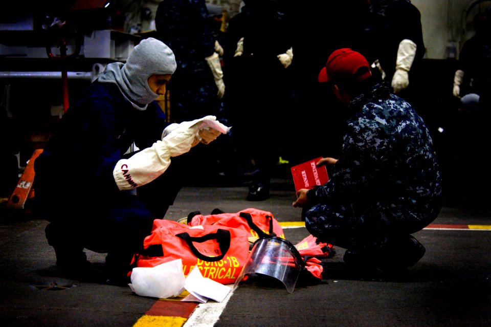 A Sailor reviews equipment during a drill. (8232067459)