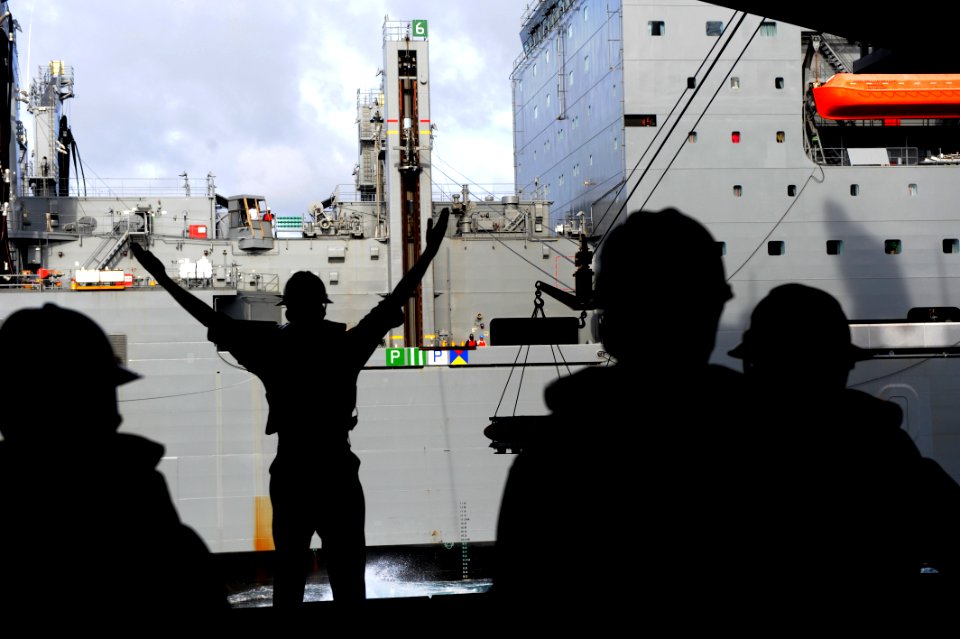 A Sailor signals USNS William Mclean during an ammo onload. (8389219741)