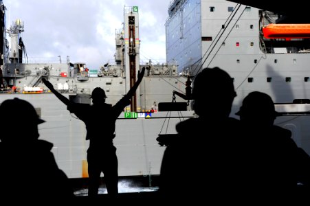 A Sailor signals USNS William Mclean during an ammo onload. (8389219741)