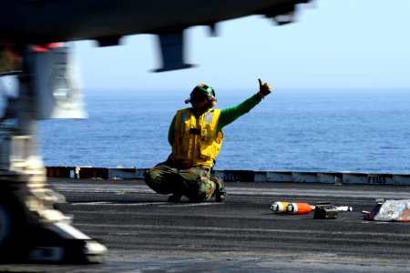 A Sailor signals for an aircraft to launch. (8570979079)