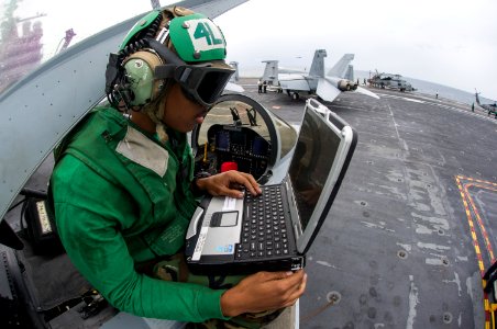 A Sailor performs maintenance on an F A-18 Hornet. (18904414684)
