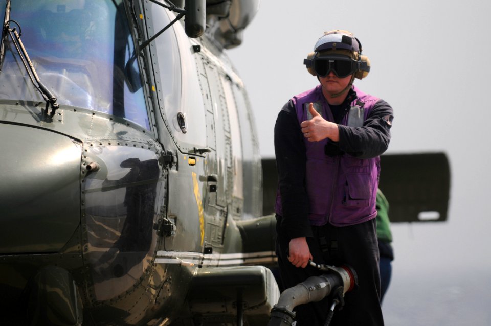 A Sailor refuels a helicopter. (8560376854)