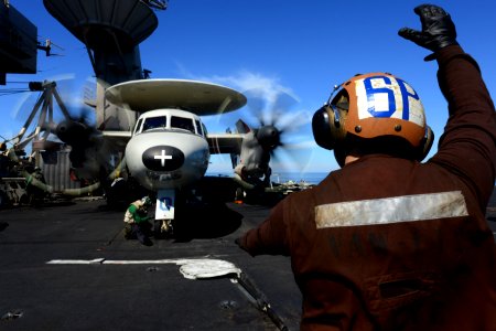 A Sailor signals the pilots of an E-2C. (8468330554)