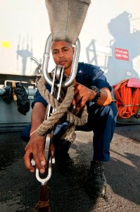 A Sailor ties dow a RHIB at sea. (8202180849)