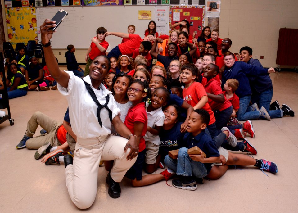 A Sailor takes a selfie with students from Lincoln Elementary Magnet School during Navy Week Tampa. (41384346024)