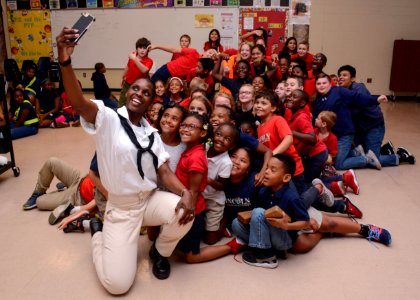 A Sailor takes a selfie with students from Lincoln Elementary Magnet School during Navy Week Tampa. (41384346024) photo