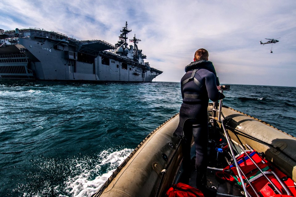 A Sailor stands watch near USS Boxer. (8253576312)