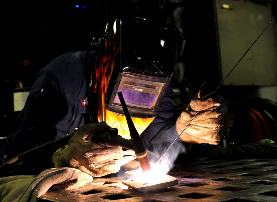 A Sailor welds a hand rail at sea. (8448064776)