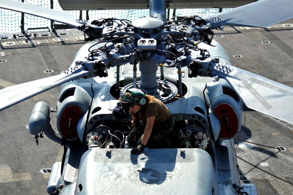 A Sailor works on an SH-60B at sea. (8224206898)