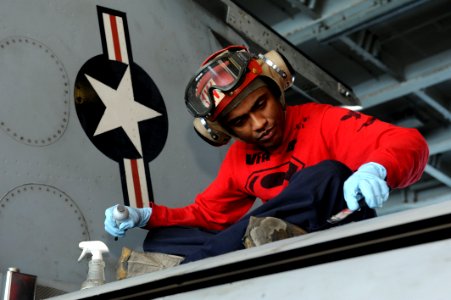 A Sailor works on an F-A-18 aboard USS John C. Stennis. (8498329846)