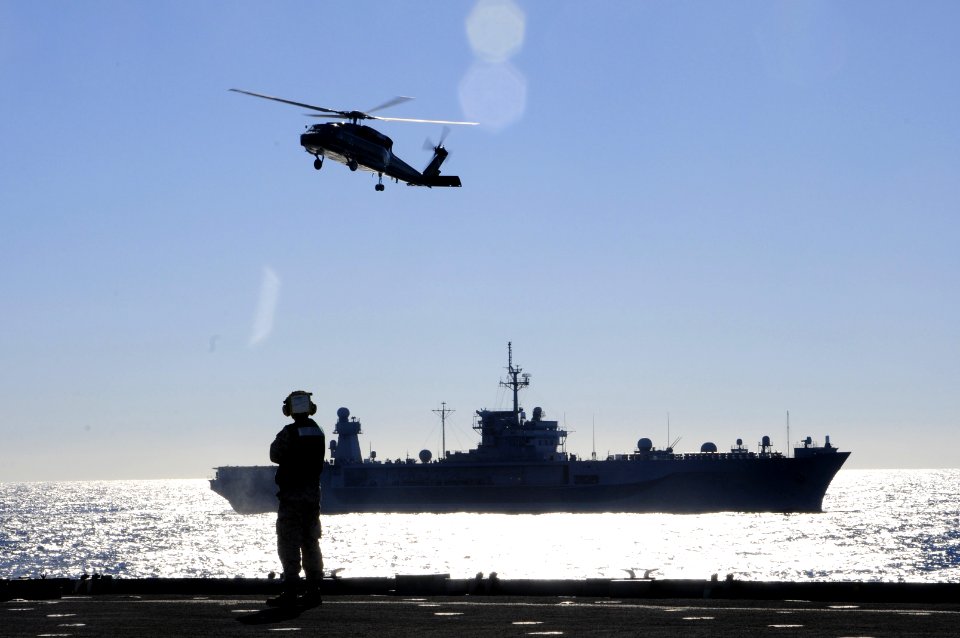 A Sailor watches as an MH-60 Sea Hawk helicopter prepares to land aboard USS Germantown (5987184617)