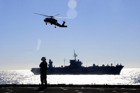 A Sailor watches as an MH-60 Sea Hawk helicopter prepares to land aboard USS Germantown (5987184617)