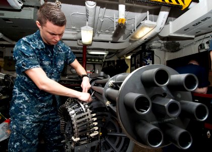 A Sailor works on an M61 A2 20 mm Gatling gun. (8428934111)