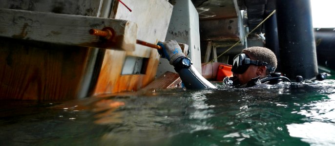 A Seabee works in the water at Pearl Harbor. (8574827906)