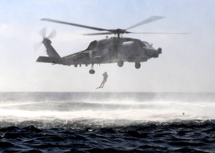 A search and rescue swimmer jumps from from an SH-60B Sea Hawk helicopter. (6852056749)