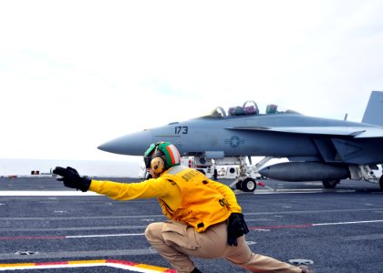 A Shooter signals an F A-18F Super Hornet at sea. (8723988698)